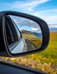 Scenic road reflection in car side mirror