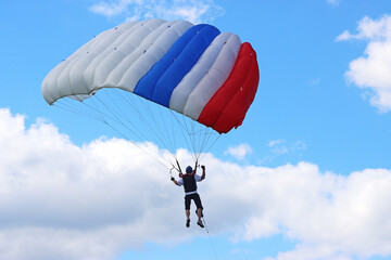 Skydiver in a blue sky	