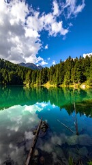 Serene alpine lake reflecting a vibrant sky. Lush forest borders a tranquil body of water, mirrored clouds and a backdrop of majestic mountains