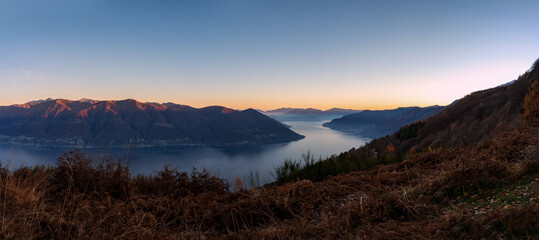 Evening panorama over lake and alpine mountains in Ticino
