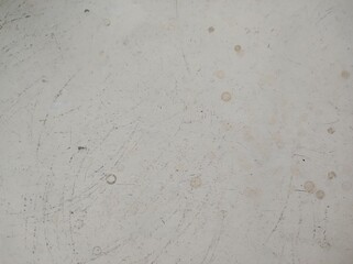 A close-up view of a microwave surface displaying various scratches, stains, and marks. The muted color palette adds a subtle aesthetic quality.