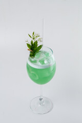 Green cocktail serving refreshing spring floral drink