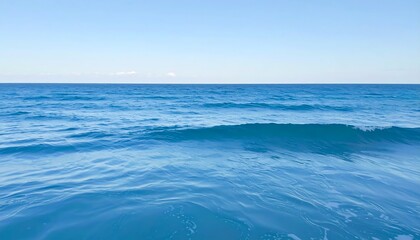 Fototapeta premium Tranquil ocean scene. Vast blue expanse. Gentle waves. Clear sky