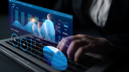 A professional working on a laptop with a holographic display showcasing various data visualizations, highlighting trends and analytics in a modern business setting. Impute