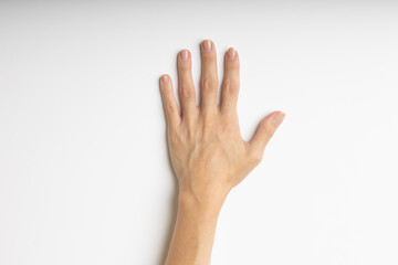 Human hand with open fingers on a white background, top view.