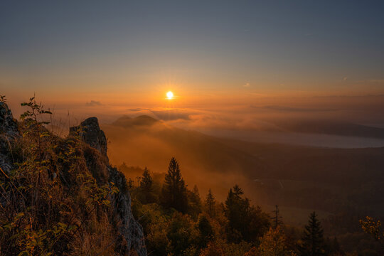 Belchenflue, Switzerland &ndash; Orange sunrise over sea of clouds in autumn
