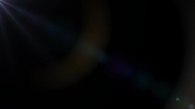 Lens flare through glass. Glare and light rays on dark alpha channel. Slow motion moving effect for overlays or transitions. Realistic graphic animated footage