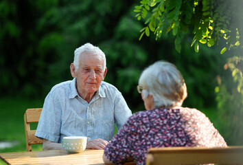 Older couple sharing moment in sunny garden