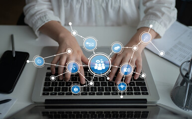 Focused hands typing on a laptop keyboard surrounded by digital icons symbolizing various aspects of communication and collaboration in a modern workspace. Tessel