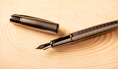 Fountain pen, beautiful fountain pen on a rustic wooden surface, selective focus.