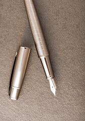 Fountain pen, beautiful fountain pen on rustic stone surface, selective focus.