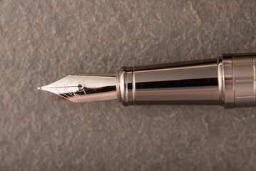 Fountain pen, beautiful fountain pen on rustic stone surface, selective focus.