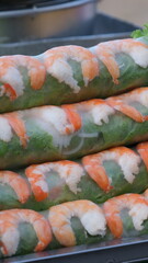 Tasty spring rolls served with lettuce on white background. High quality photo
