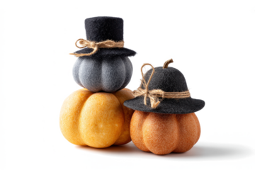 Festive fall pumpkins stacked with hats decorative autumn centerpiece for Thanksgiving and Halloween isolated on white