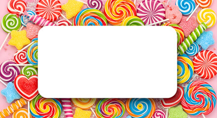 Fototapeta premium Colorful lollipops and candies frame with white copy space sweet sugar bonbons with blank area for text isolated on white background