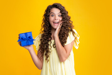 Cute teenager child girl congratulate with valentines day, giving romantic gift box. Present, greeting and gifting birthday concept. Excited teenager, glad amazed and overjoyed emotions.