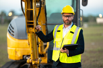 Construction business owner. Man in suit and hardhat halmet at building construction site. Civil engineer worker in front of house near excavator. Architect, supervisor investor, construction manager.