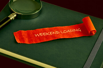 A notebook sits ready for weekend plans. A bright orange scroll reads weekend loading, and a magnifying glass hints at exploration or detailed planning for the coming days of leisure