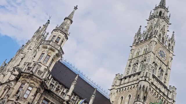Clock Tower or Glockenspiel close-up, Munich, Germany. 03. 10. 2025. Detail of Rathaus New Town Hall with chime in city center. Located on Marienplatz square. Looking up perspective. Slow motion