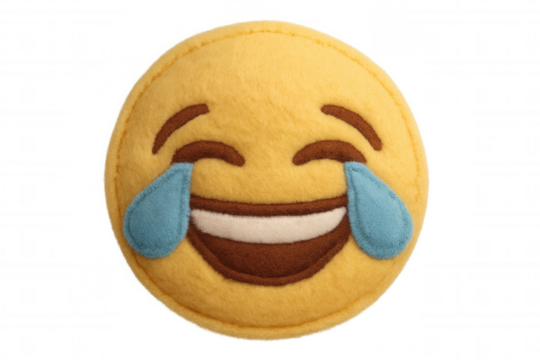Laughing tears of joy emoji pillow expressing happiness and humor, social media communication fun concept