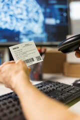 Close up of employee uses AI brain automation and scan shipping labels, registering barcodes with...