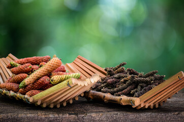 Fresh and dried piper longum on natural background.