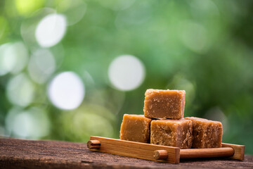Sugar cane juice cubes or Brown Cane Sugar Cube on natural background.