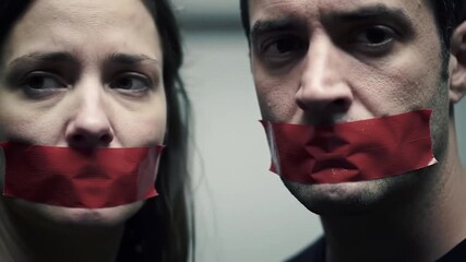 Close-up of a man and woman with red tape over their mouths, against a neutral background, conveying silence and suppressed voices