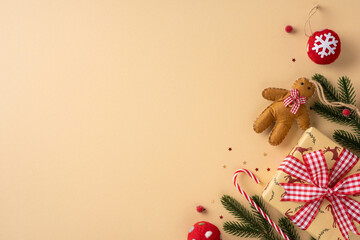 Naklejka na ściany i meble A warm holiday setup featuring wrapped presents, a red bow, candy cane, gingerbread figure, and pine branches, perfect for Christmas and New Year visuals conveying warmth and festive mood