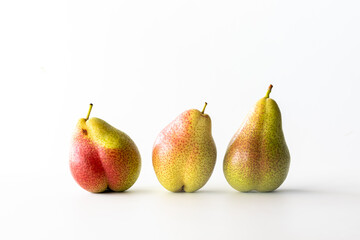 Fresh organic Forelle pears isolated against a white background.
