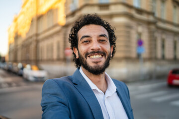 Fototapeta premium Self portrait of smiling businessman posing and smile on city street