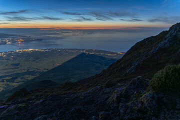 Shadow of Mount Pico Casted by Full Moon at Night. Atlantic Ocean and Mountain Slope. Pico Island, Azores. Portugal