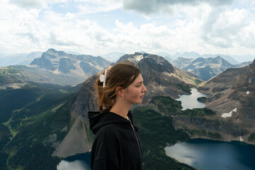 Naklejka premium Woman gazing at mountain vista, peaceful, enjoying the view.
