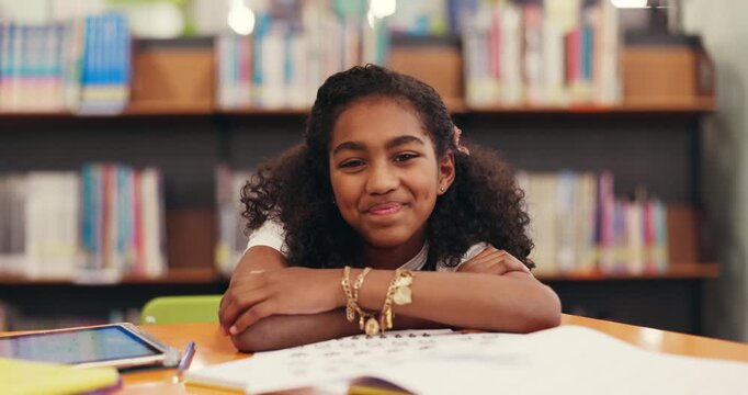 Girl, child and face at library with education, smile or arms crossed with pride with project at school. Kid, portrait and pupil with confidence for development, scholarship and learning in Brazil