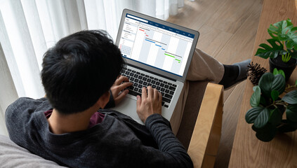 Project planning software for modish business project management on the computer screen showing timeline chart of the team project