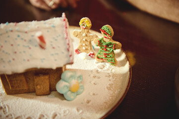 Gingerbread House Snow Scene With Decorated Cookies On Plate For Christmas
