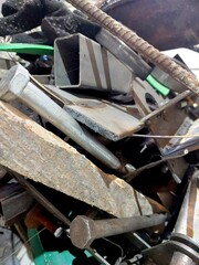 Scrap Metal Piled High in a Recycling Yard Showing Various Materials During the Late Afternoon
