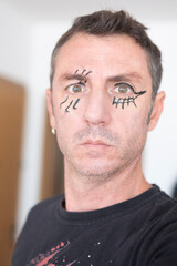 Fototapeta premium Man with face made up for Halloween. The man is forty years old and of Caucasian origin
