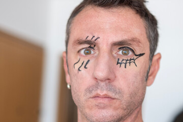 Man with face made up for Halloween. The man is forty years old and of Caucasian origin