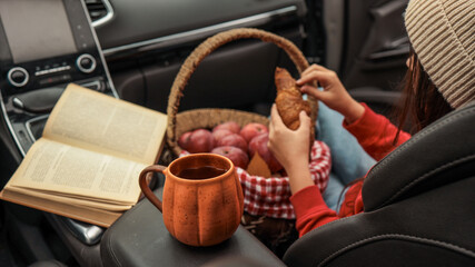 Cozy car picnic with a book and fresh pastries
