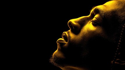 Profile silhouette human face illuminated with golden light transparency