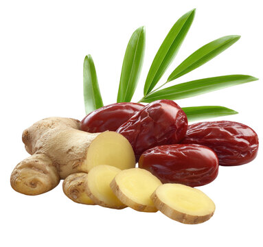 Fresh sliced ginger root with red jujube dates and green leaves.