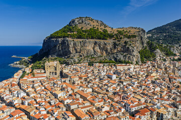 Aerial drone view of Cefalu historic medieval old town with cathedral beach and turquoise Tyrrhenian Sea in summer on northern coast of Sicily island southern Italy Europe Mediterranean destination