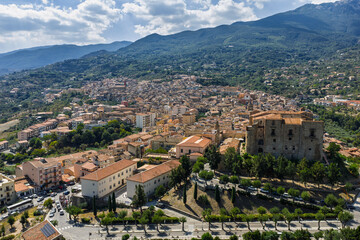 Obraz premium Aerial drone view of Castelbuono medieval town in the Madonie Mountains, Sicily, Italy, basking under the summer sun with historic streets, Ventimiglia Castle. Old mountain town in Sicily