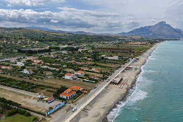 Aerial drone view of Campofelice di Roccella, a charming Sicilian seaside town in northern Sicily, Italy, showing traditional holiday homes, coastline, and panoramic Tyrrhenian Sea vistas