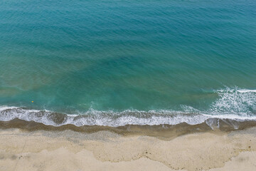 Aerial drone view of Campofelice di Roccella, a charming Sicilian seaside town in northern Sicily, Italy, showing traditional holiday homes, coastline, and panoramic Tyrrhenian Sea vistas