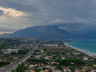 Obraz premium Aerial drone view of Campofelice di Roccella, a charming Sicilian seaside town in northern Sicily, Italy, showing traditional holiday homes, coastline, and panoramic Tyrrhenian Sea vistas