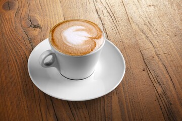 A steaming cup of aroma coffee on desk