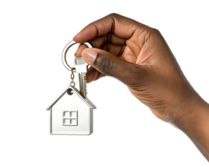 Hand holding a house shaped keychain with a key attached on a black isolated background studio shot