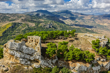Fototapeta premium Aerial drone view of Caltavuturo, a historic Sicilian mountain town in Palermo, Italy, featuring its medieval castle, rugged surrounding cliffs, and scenic landscapes of the Madonie Mountains